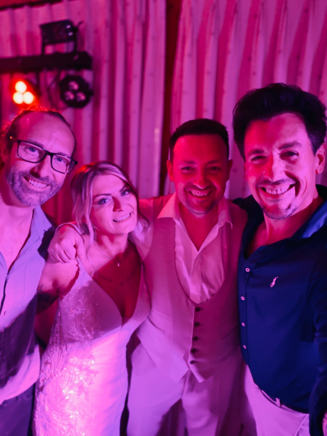 Matt and his guitarist celebrating with a bride and groom